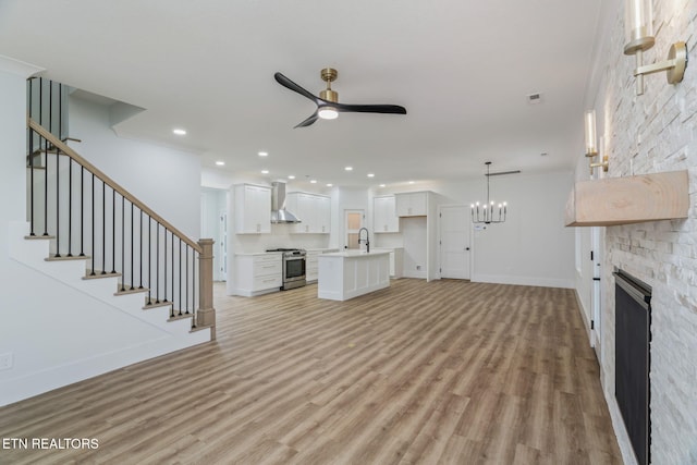 2210 Hickory Crest Ln, Knoxville, TN 37932 - unfurnished living room with a ceiling fan, a stone fireplace, light wood-style flooring, a sink, and recessed lighting