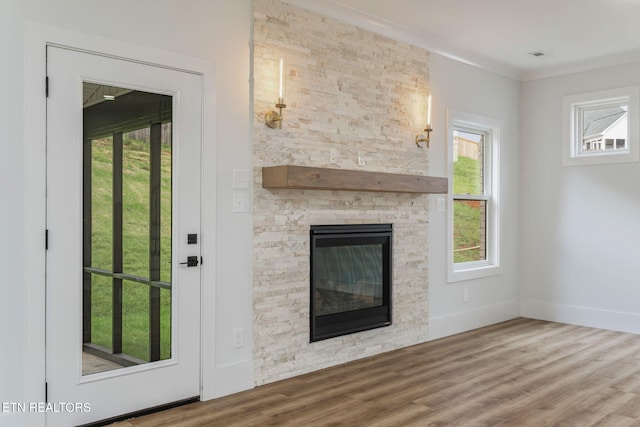 2210 Hickory Crest Ln, Knoxville, TN 37932 - unfurnished living room featuring plenty of natural light, wood finished floors, and a stone fireplace