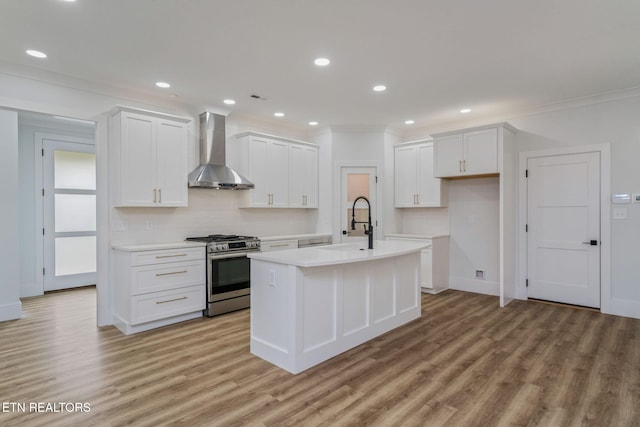 2210 Hickory Crest Ln, Knoxville, TN 37932 - kitchen with gas range, wall chimney range hood, a sink, crown molding, and a center island with sink