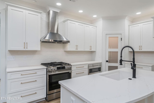 2210 Hickory Crest Ln, Knoxville, TN 37932 - kitchen with wall chimney exhaust hood, stainless steel gas range, a sink, white cabinetry, and recessed lighting