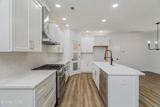 2210 Hickory Crest Ln, Knoxville, TN 37932 - kitchen with stainless steel appliances, a sink, light wood-style flooring, wall chimney exhaust hood, and backsplash