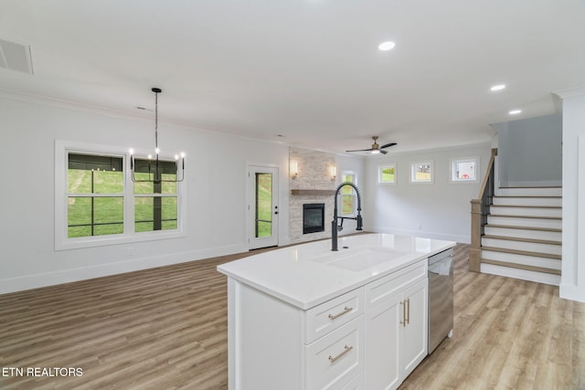2210 Hickory Crest Ln, Knoxville, TN 37932 - kitchen with a sink, stainless steel dishwasher, open floor plan, a stone fireplace, and ceiling fan