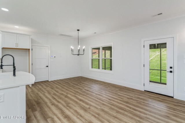 2210 Hickory Crest Ln, Knoxville, TN 37932 - unfurnished dining area featuring crown molding, a chandelier, light wood-style flooring, recessed lighting, and healthy amount of natural light
