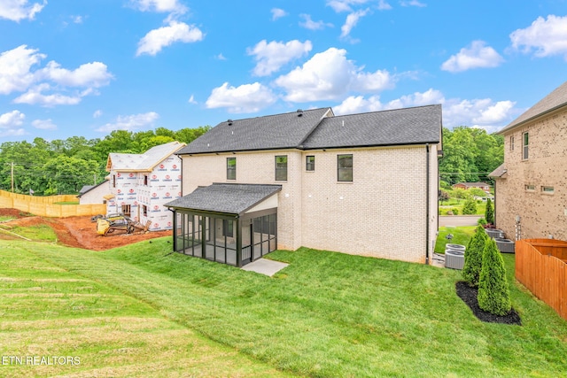 2210 Hickory Crest Ln, Knoxville, TN 37932 - back of property with a sunroom, central AC unit, brick siding, and roof with shingles