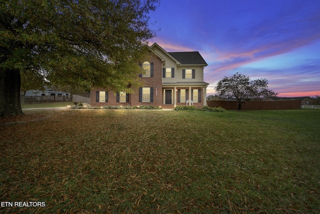 colonial-style house featuring a yard