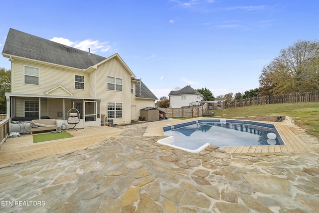 view of swimming pool featuring a wooden deck and a patio area