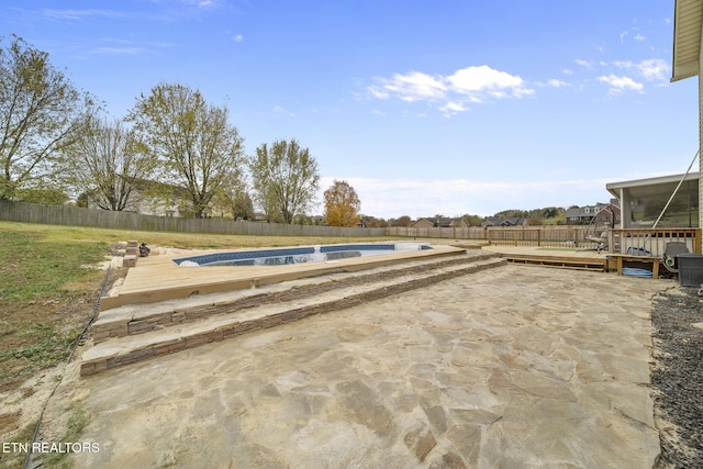 view of swimming pool featuring a patio area and a deck