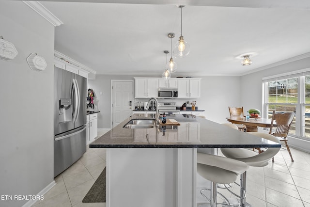 kitchen featuring white cabinets, sink, crown molding, and stainless steel appliances