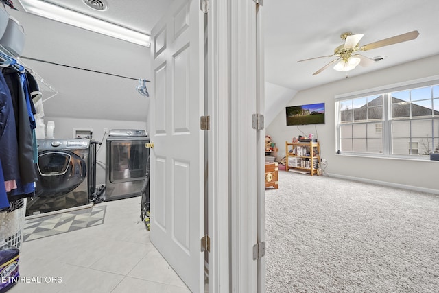 washroom featuring a textured ceiling, washing machine and dryer, light tile patterned flooring, and ceiling fan