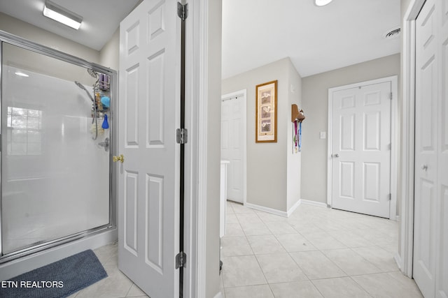 bathroom featuring walk in shower and tile patterned floors