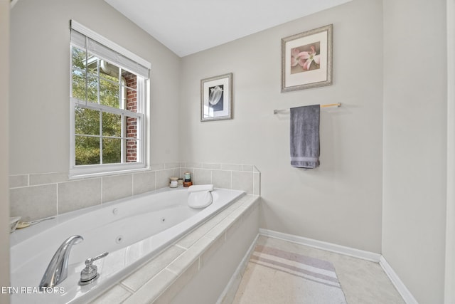 bathroom featuring a relaxing tiled tub and tile patterned flooring