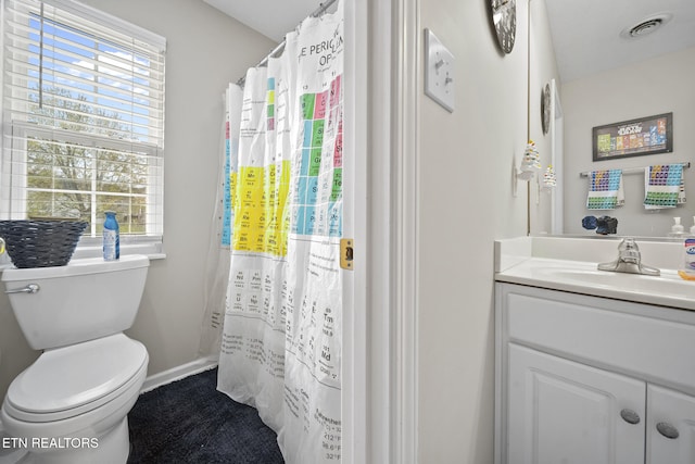 bathroom featuring vanity and toilet