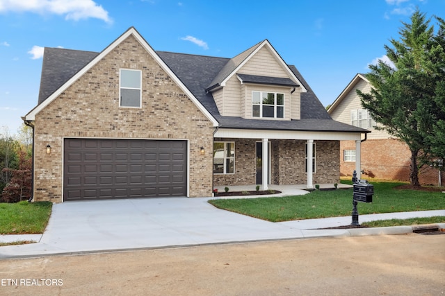 view of front of property featuring covered porch, a garage, and a front yard