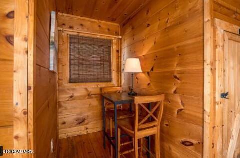 living area featuring wood walls, wood ceiling, and hardwood / wood-style flooring