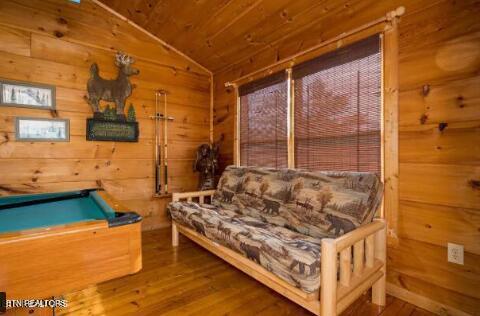 playroom with wooden walls, wood ceiling, vaulted ceiling, hardwood / wood-style flooring, and pool table