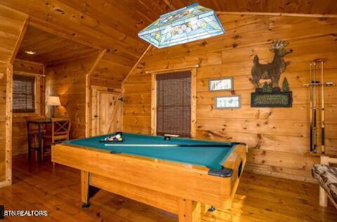 game room with wooden ceiling, hardwood / wood-style flooring, wood walls, pool table, and lofted ceiling