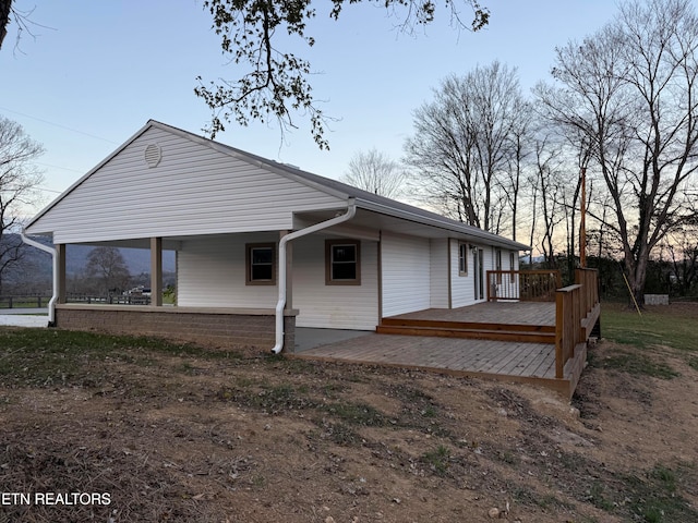 property exterior at dusk with a deck