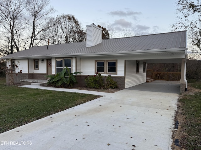 1184 Davis Chapel Rd, Lafollette, TN 37766 - ranch-style home with concrete driveway, a chimney, an attached carport, a front yard, and metal roof