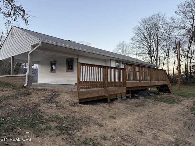 1184 Davis Chapel Rd, Lafollette, TN 37766 - back of property with a carport, a wooden deck, and metal roof