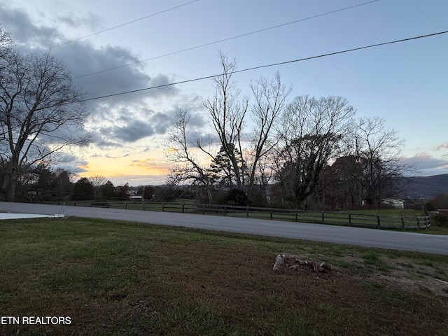 view of yard at dusk