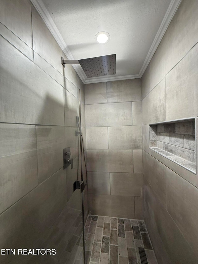 details featuring crown molding, a textured ceiling, and a tile shower