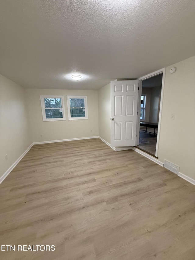 1184 Davis Chapel Rd, Lafollette, TN 37766 - spare room featuring wood finished floors, baseboards, a textured ceiling, and a smoke detector