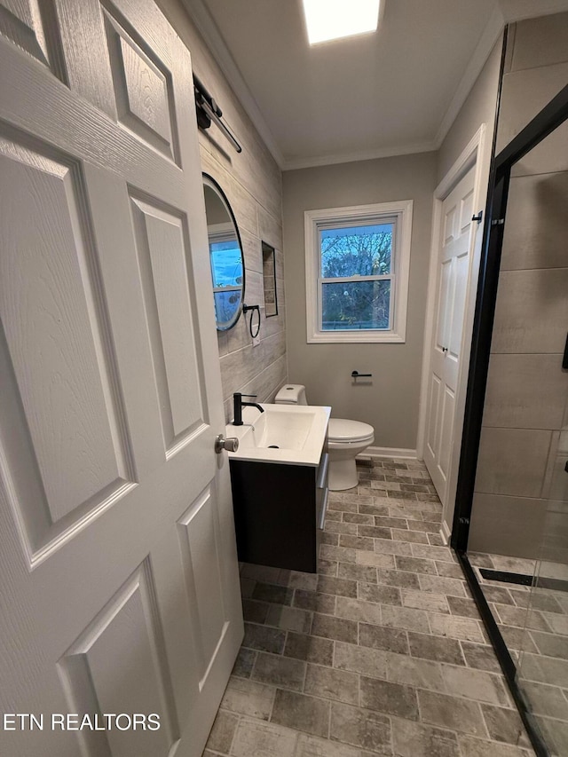 bathroom featuring walk in shower, vanity, toilet, and ornamental molding