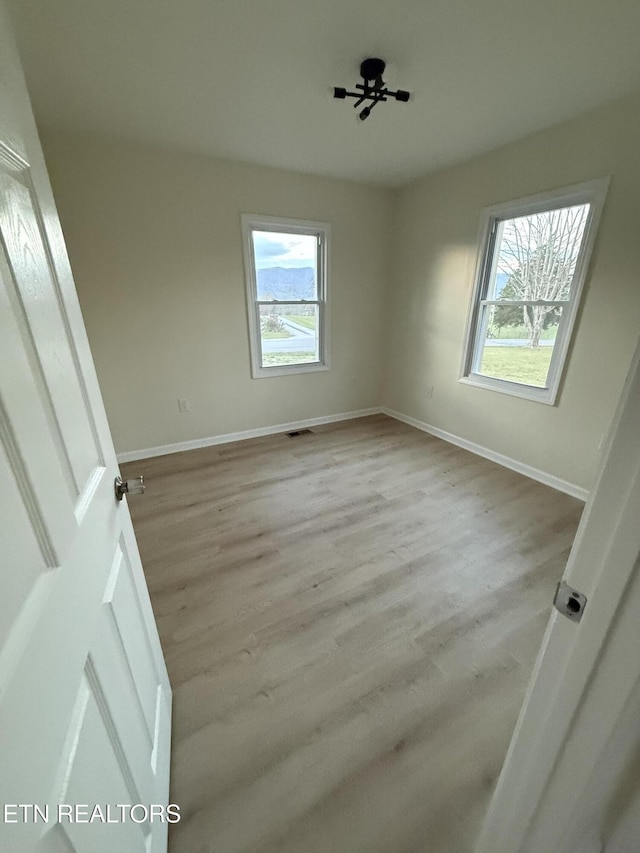 1184 Davis Chapel Rd, Lafollette, TN 37766 - empty room with healthy amount of natural light, wood finished floors, and baseboards