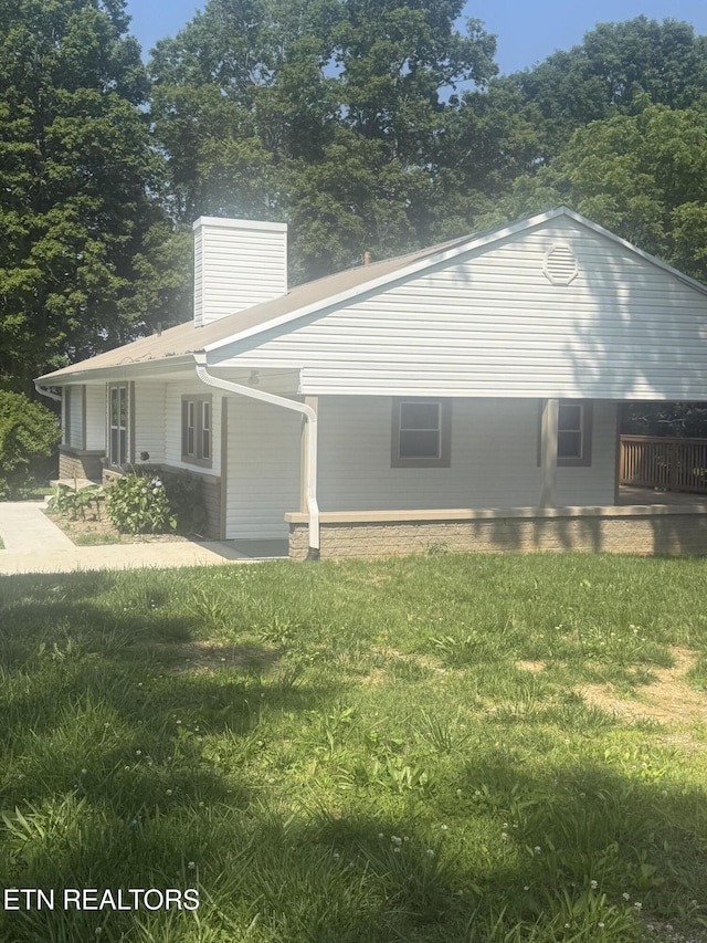 1184 Davis Chapel Rd, Lafollette, TN 37766 - view of property exterior featuring a lawn and a chimney