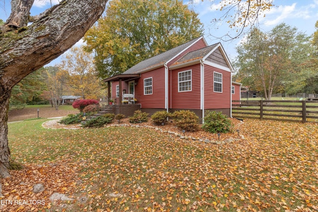 view of side of property with a yard