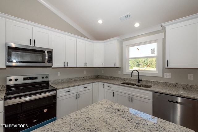 6105 Lanier Rd, Maryville, TN 37801 - kitchen with appliances with stainless steel finishes, a sink, lofted ceiling, white cabinets, and light stone countertops