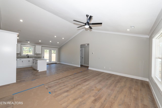 6105 Lanier Rd, Maryville, TN 37801 - unfurnished living room featuring a sink, light wood-style flooring, a ceiling fan, baseboards, and crown molding