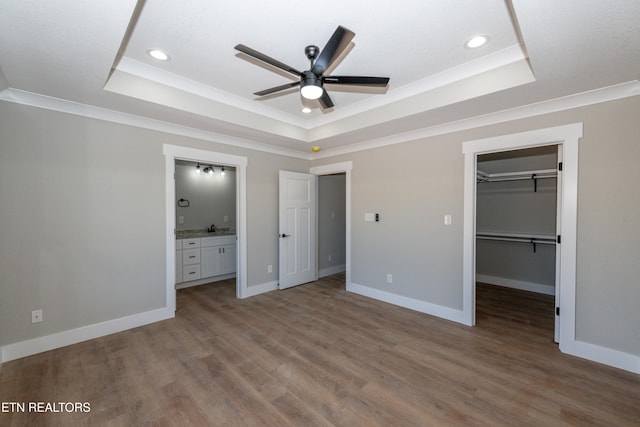 6105 Lanier Rd, Maryville, TN 37801 - unfurnished bedroom with a tray ceiling, wood finished floors, a spacious closet, recessed lighting, and ornamental molding