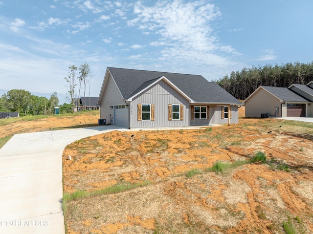 6105 Lanier Rd, Maryville, TN 37801 - modern farmhouse with board and batten siding, driveway, cooling unit, an attached garage, and roof with shingles