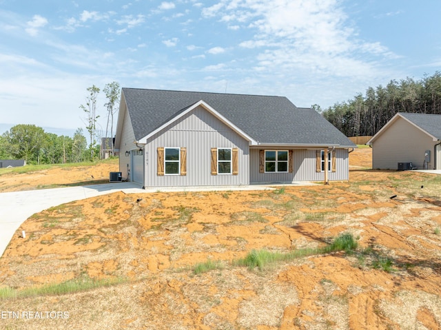 6105 Lanier Rd, Maryville, TN 37801 - view of front facade featuring concrete driveway, a shingled roof, board and batten siding, a garage, and cooling unit
