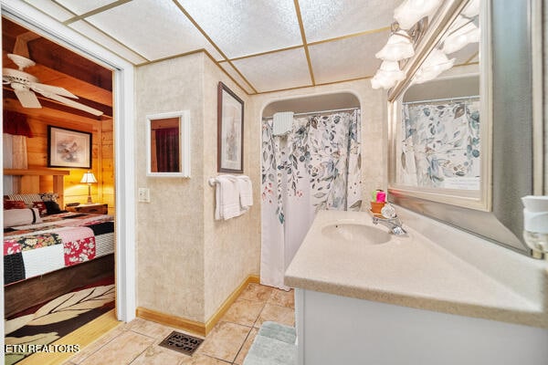 bathroom featuring tile patterned flooring, vanity, curtained shower, and ceiling fan