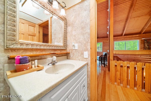 bathroom featuring vanity, wood ceiling, and hardwood / wood-style flooring