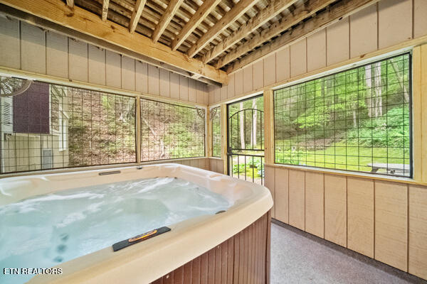 unfurnished sunroom featuring a jacuzzi