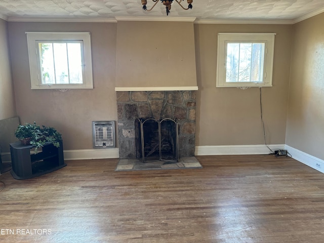 unfurnished living room featuring heating unit, wood-type flooring, and crown molding