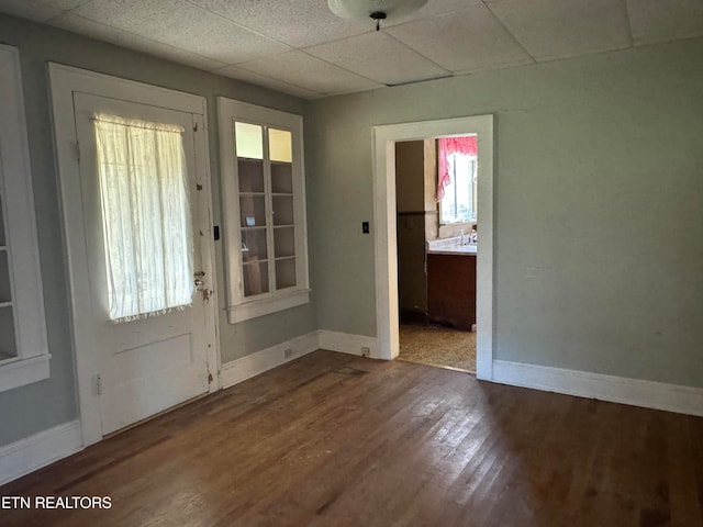 foyer entrance featuring hardwood / wood-style flooring and a drop ceiling