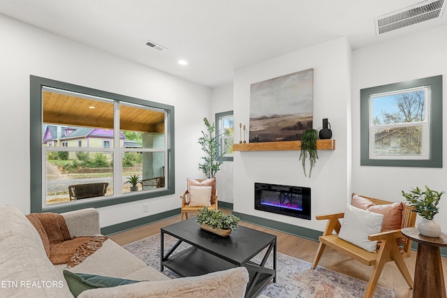 living room featuring hardwood / wood-style floors, a wealth of natural light, and wood ceiling