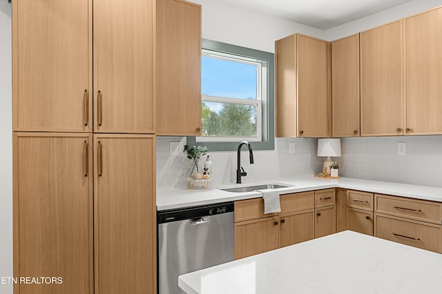 kitchen featuring dishwasher, light brown cabinets, sink, and tasteful backsplash