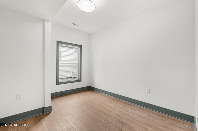 spare room with hardwood / wood-style floors