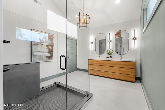 bathroom featuring an enclosed shower, vanity, and an inviting chandelier