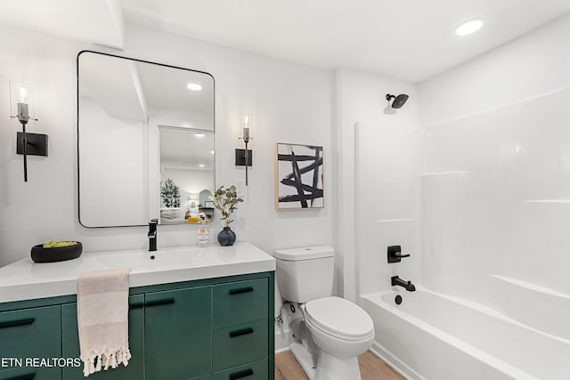 full bathroom featuring vanity, hardwood / wood-style flooring, toilet, and shower / bathtub combination