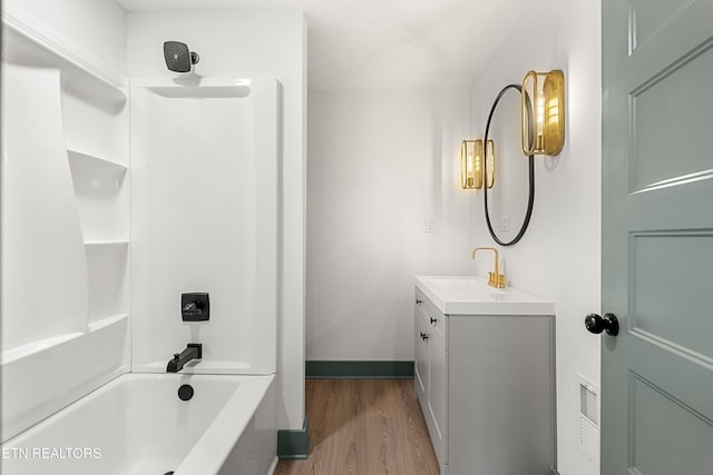 bathroom with vanity, wood-type flooring, and shower / bathtub combination