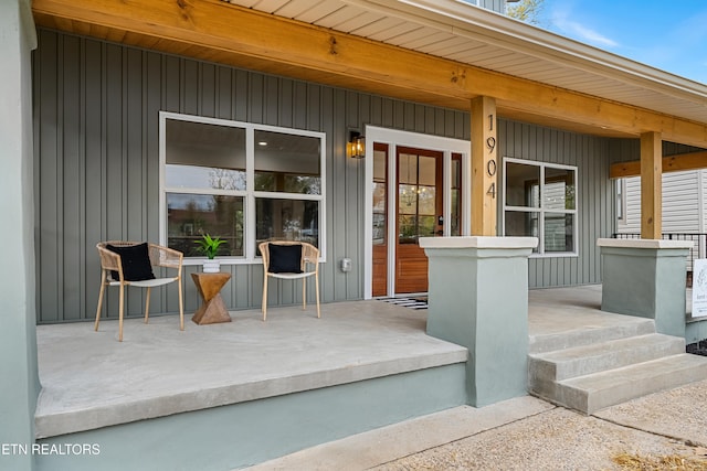 view of exterior entry featuring covered porch