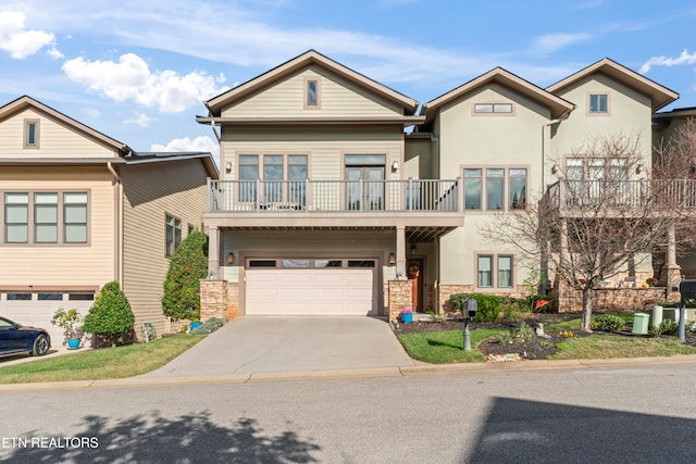 view of property with a garage and a balcony