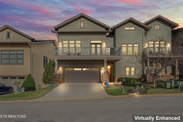 1144 Andalusian Way, Knoxville, TN 37922 - view of front facade with a balcony, stone siding, driveway, an attached garage, and stucco siding