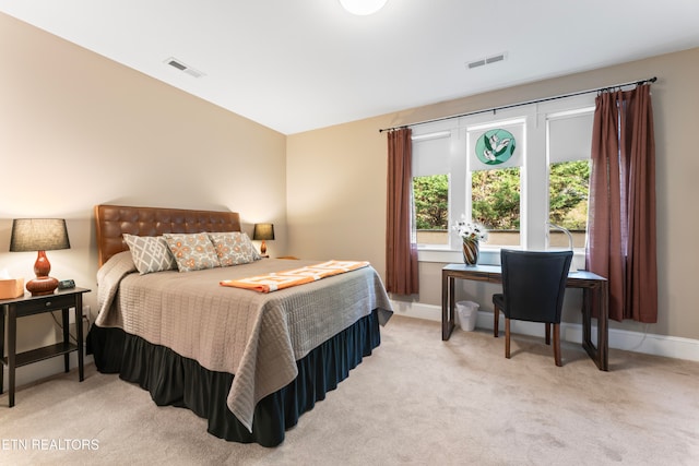 bedroom featuring light carpet